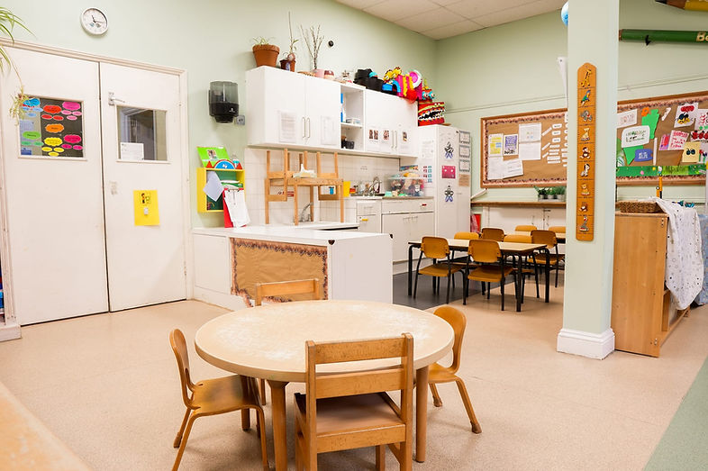 A Beckett House classroom with child-sized tables, chairs and learning materials